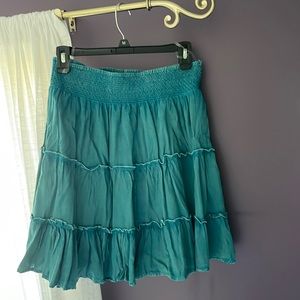 Teal colored skirt.